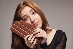 Portrait of sad young girl with the big chocolate